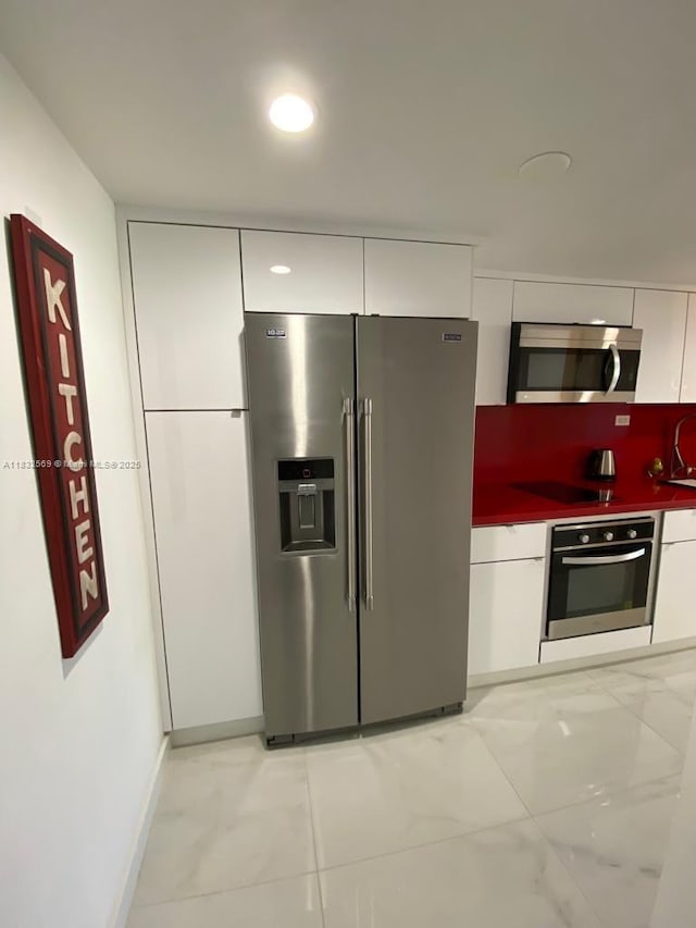 19201 Collins Ave Unit 130, Sunny Isles Beach, FL 33160 - kitchen with appliances with stainless steel finishes, modern cabinets, white cabinets, and dark countertops