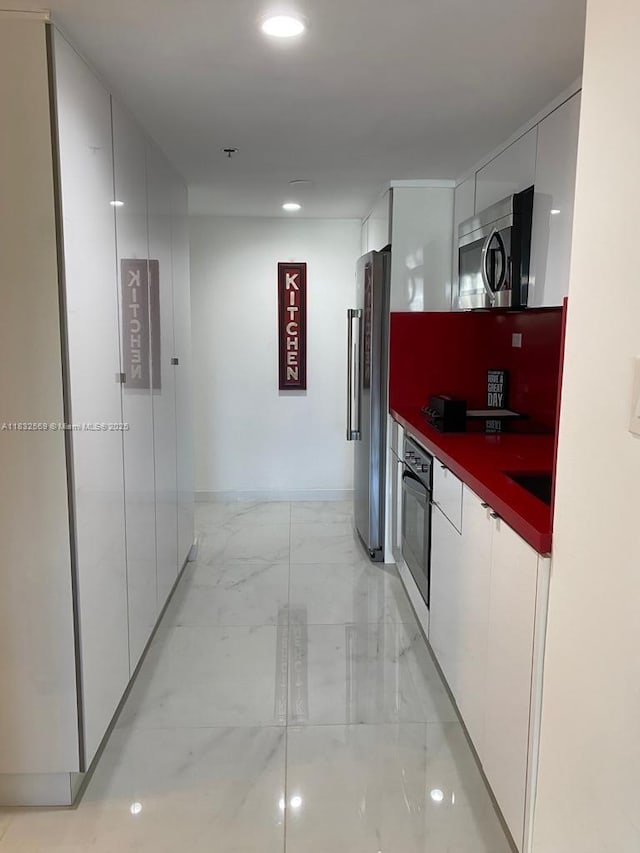 19201 Collins Ave Unit 130, Sunny Isles Beach, FL 33160 - kitchen with stainless steel appliances, modern cabinets, light marble finish floors, and recessed lighting