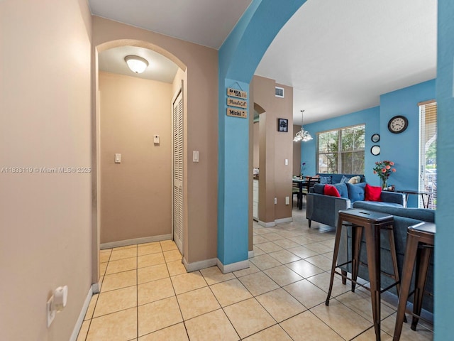 8912 W Flagler St Unit 103, Miami, FL 33174 - kitchen featuring arched walkways, light tile patterned floors, and a chandelier
