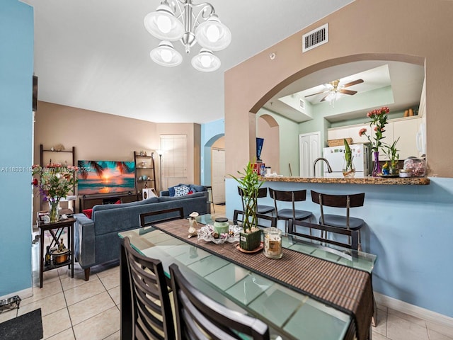 8912 W Flagler St Unit 103, Miami, FL 33174 - dining room featuring arched walkways, a ceiling fan, light tile patterned flooring, and a chandelier