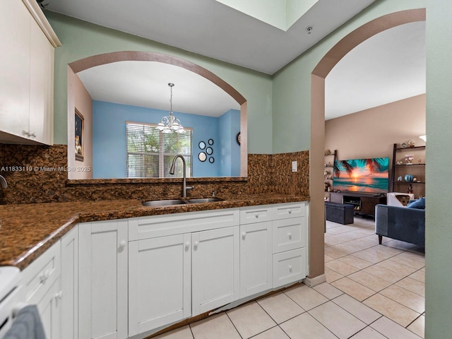 8912 W Flagler St Unit 103, Miami, FL 33174 - kitchen with backsplash, a chandelier, light tile patterned flooring, white cabinets, and dark stone counters