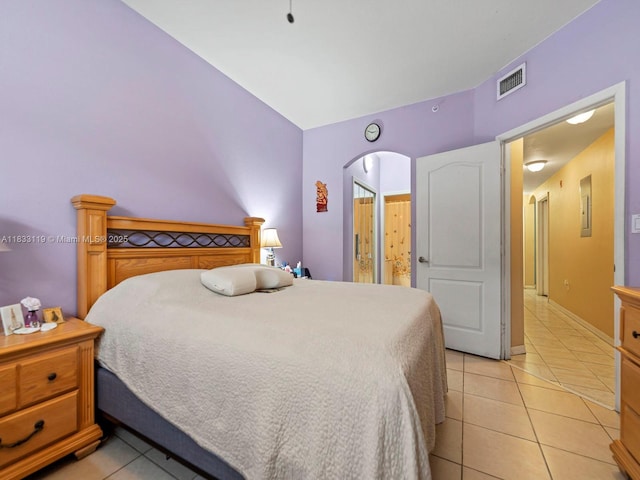 8912 W Flagler St Unit 103, Miami, FL 33174 - bedroom with light tile patterned floors, arched walkways, and connected bathroom