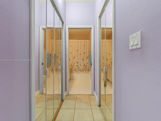 8912 W Flagler St Unit 103, Miami, FL 33174 - hallway featuring light tile patterned floors and baseboards