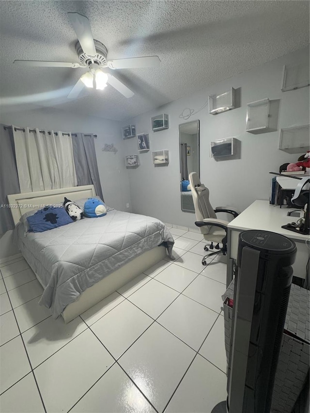 5072 W 12th Ln Unit D-14, Hialeah, FL 33012 - bedroom with a textured ceiling, light tile patterned floors, and a ceiling fan
