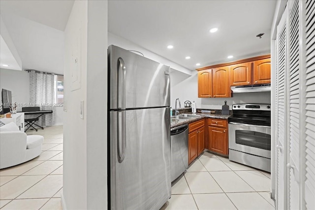 540 Brickell Key Dr Unit 412, Miami, FL 33131 - kitchen featuring appliances with stainless steel finishes, under cabinet range hood, light tile patterned floors, recessed lighting, and brown cabinetry