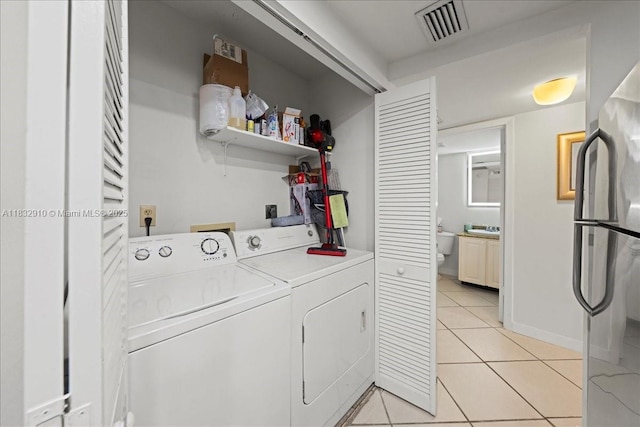 540 Brickell Key Dr Unit 412, Miami, FL 33131 - washroom featuring washer and dryer and light tile patterned floors