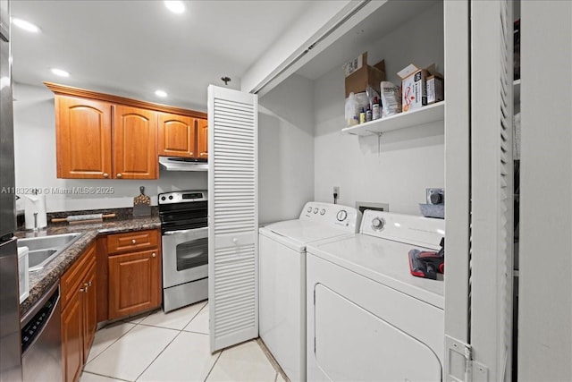 540 Brickell Key Dr Unit 412, Miami, FL 33131 - washroom with separate washer and dryer, light tile patterned floors, and recessed lighting