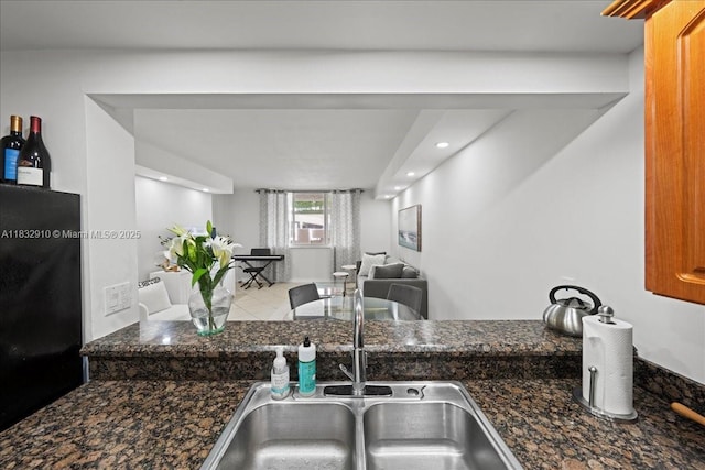 540 Brickell Key Dr Unit 412, Miami, FL 33131 - kitchen with freestanding refrigerator, recessed lighting, open floor plan, and dark stone counters
