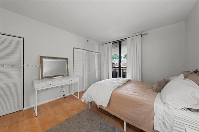 540 Brickell Key Dr Unit 412, Miami, FL 33131 - bedroom featuring access to exterior and wood finished floors