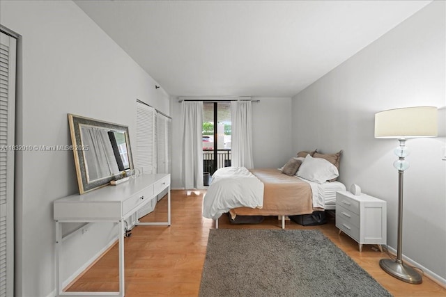 540 Brickell Key Dr Unit 412, Miami, FL 33131 - bedroom with access to exterior and light wood-style flooring