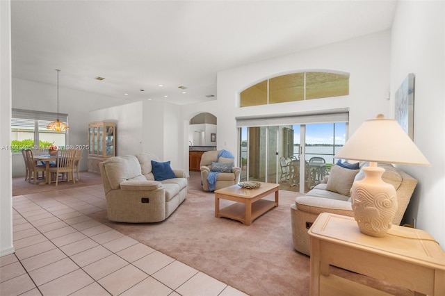 2373 NW 195th Ave, Pembroke Pines, FL 33029 - living area featuring light tile patterned floors, arched walkways, healthy amount of natural light, light carpet, and recessed lighting