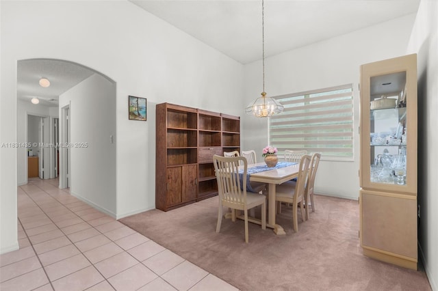 2373 NW 195th Ave, Pembroke Pines, FL 33029 - carpeted dining space with a chandelier, arched walkways, and tile patterned floors