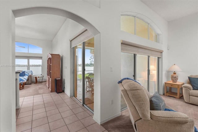 2373 NW 195th Ave, Pembroke Pines, FL 33029 - interior space featuring a water view, light colored carpet, arched walkways, a towering ceiling, and light tile patterned floors