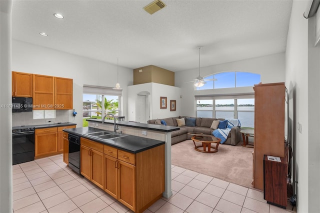2373 NW 195th Ave, Pembroke Pines, FL 33029 - kitchen featuring black appliances, dark countertops, a ceiling fan, light carpet, and light tile patterned flooring