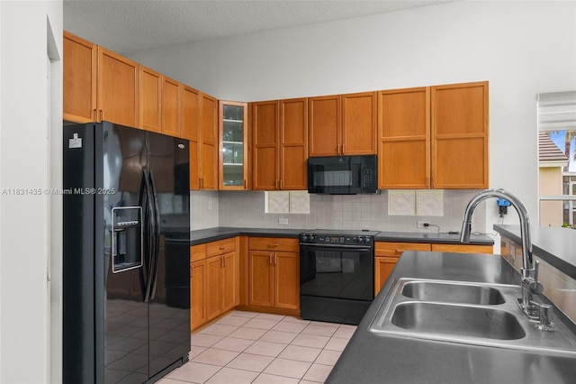 2373 NW 195th Ave, Pembroke Pines, FL 33029 - kitchen with black appliances, decorative backsplash, light tile patterned flooring, dark countertops, and glass insert cabinets