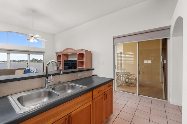2373 NW 195th Ave, Pembroke Pines, FL 33029 - kitchen with dark countertops, light tile patterned floors, brown cabinets, and ceiling fan