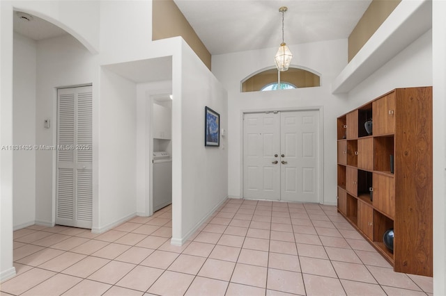 2373 NW 195th Ave, Pembroke Pines, FL 33029 - entrance foyer with washer / dryer, light tile patterned flooring, arched walkways, and a chandelier