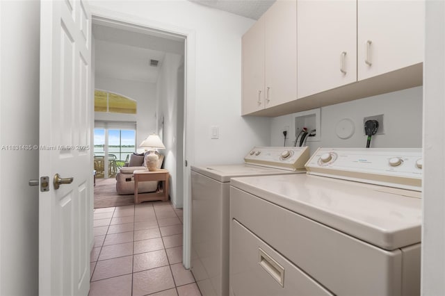 2373 NW 195th Ave, Pembroke Pines, FL 33029 - washroom featuring cabinet space, independent washer and dryer, and light tile patterned flooring