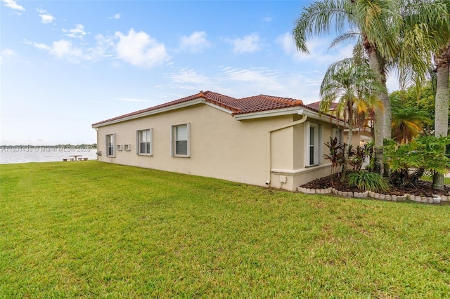 2373 NW 195th Ave, Pembroke Pines, FL 33029 - view of side of home featuring a water view, a tile roof, stucco siding, and a lawn