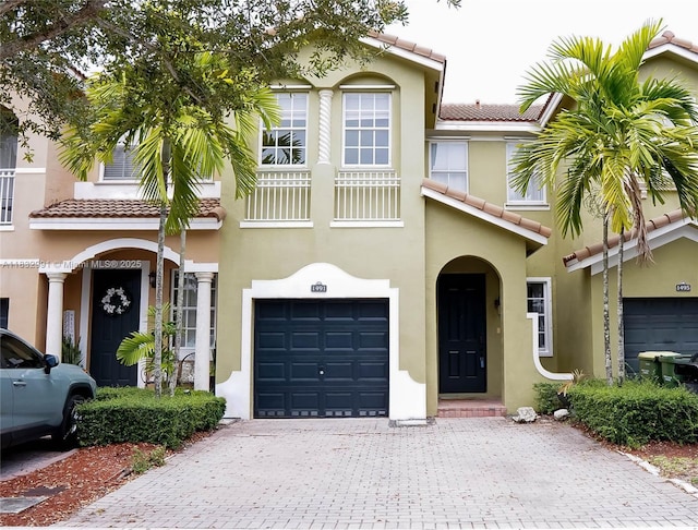 1491 SE 25th Ter Unit 1491, Homestead, FL 33035 - townhome / multi-family property with a tile roof, stucco siding, decorative driveway, and an attached garage
