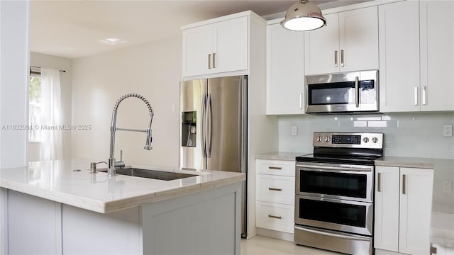 1491 SE 25th Ter Unit 1491, Homestead, FL 33035 - kitchen with appliances with stainless steel finishes, light stone countertops, white cabinets, and backsplash