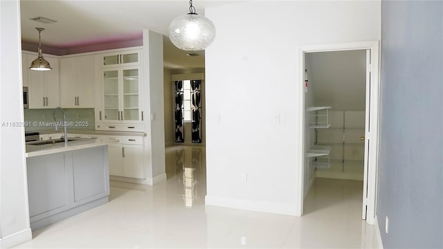 1491 SE 25th Ter Unit 1491, Homestead, FL 33035 - kitchen featuring glass insert cabinets, white cabinetry, light countertops, and decorative light fixtures