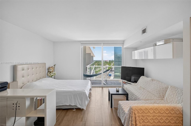4250 Biscayne Blvd Unit 1206, Miami, FL 33137 - bedroom featuring wood finished floors and a wall of windows