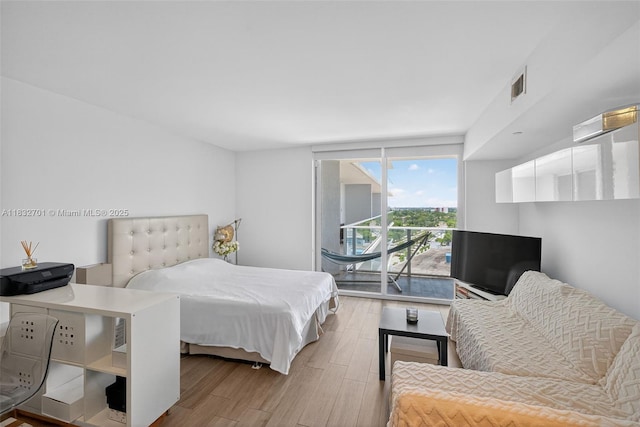 4250 Biscayne Blvd Unit 1206, Miami, FL 33137 - bedroom featuring wood finished floors and access to outside
