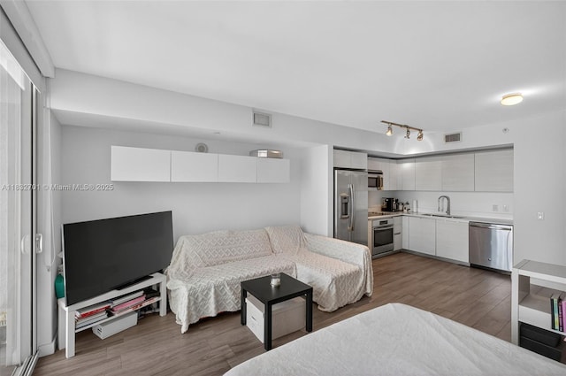 4250 Biscayne Blvd Unit 1206, Miami, FL 33137 - living room featuring wood finished floors and rail lighting