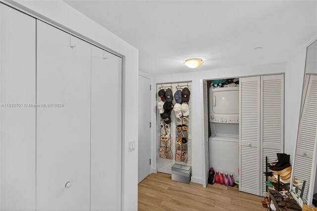 4250 Biscayne Blvd Unit 1206, Miami, FL 33137 - bedroom featuring estacked washer and dryer and light wood-type flooring