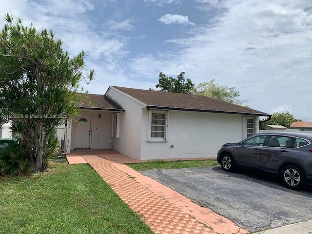 13375 NW 3rd Ter, Miami, FL 33182 - ranch-style house featuring stucco siding and a front lawn