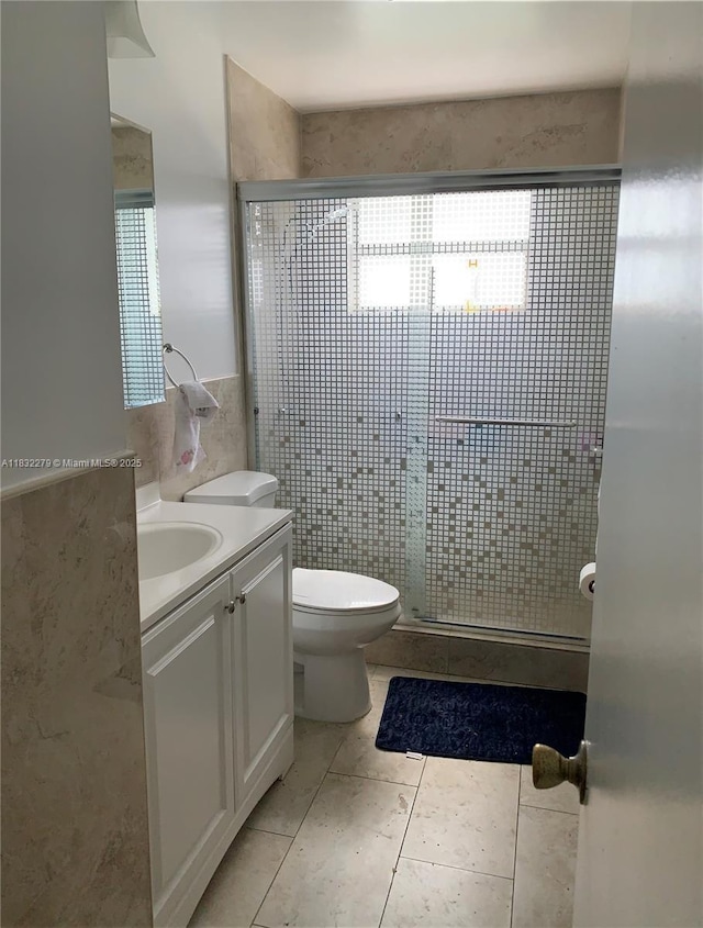 13375 NW 3rd Ter, Miami, FL 33182 - full bathroom featuring vanity, tile walls, a stall shower, and tile patterned flooring