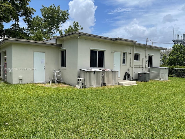 6250 SW 16th Ter, West Miami, FL 33155 - back of property featuring a hot tub, stucco siding, and a yard