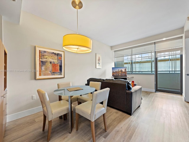 1395 Brickell Ave Unit 3310, Miami, FL 33131 - dining room featuring light wood finished floors and baseboards