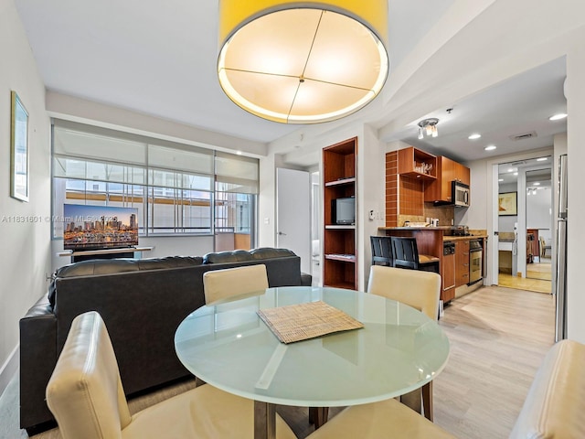 1395 Brickell Ave Unit 3310, Miami, FL 33131 - dining room with light wood-style floors and recessed lighting