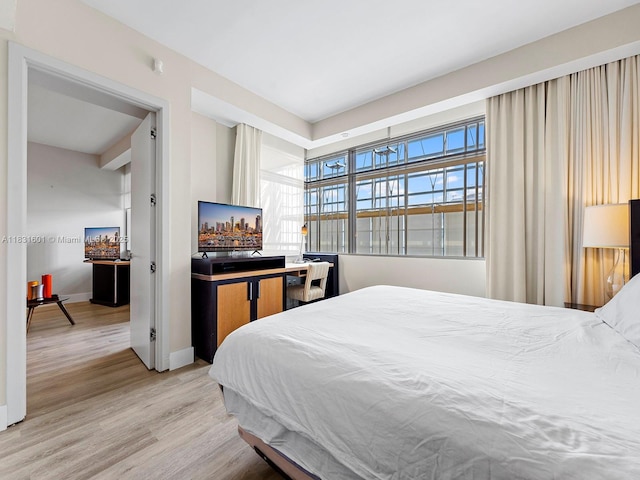1395 Brickell Ave Unit 3310, Miami, FL 33131 - bedroom featuring light wood-style flooring and baseboards