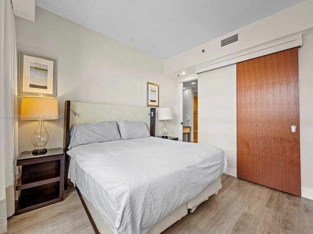 1395 Brickell Ave Unit 3310, Miami, FL 33131 - bedroom featuring light wood-style floors and a closet