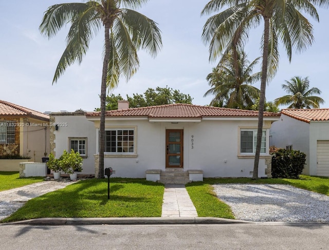9033 Carlyle Ave, Surfside, FL 33154 - mediterranean / spanish home featuring a tile roof, stucco siding, a front lawn, and a chimney