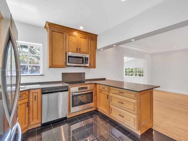 9033 Carlyle Ave, Surfside, FL 33154 - kitchen featuring appliances with stainless steel finishes, a peninsula, recessed lighting, dark countertops, and granite tiled floors