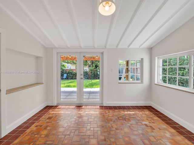 9033 Carlyle Ave, Surfside, FL 33154 - unfurnished room featuring lofted ceiling, healthy amount of natural light, brick flooring, and french doors