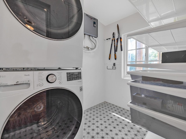 9033 Carlyle Ave, Surfside, FL 33154 - laundry room with tile patterned floors and stacked washing machine and dryer