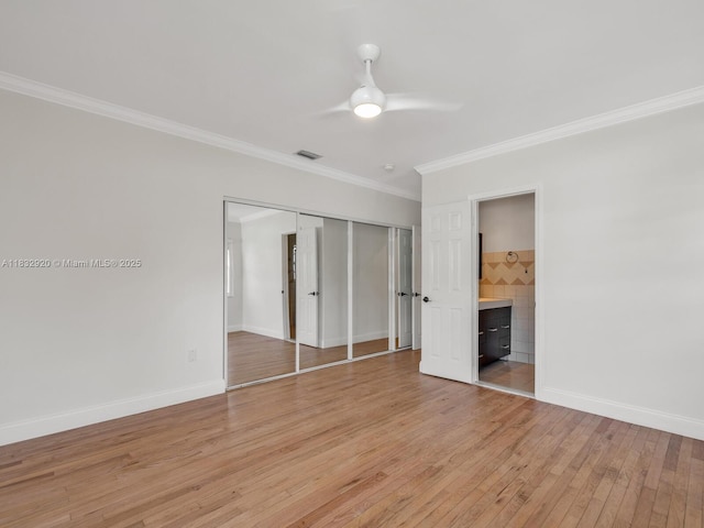 9033 Carlyle Ave, Surfside, FL 33154 - unfurnished bedroom featuring ornamental molding, light wood-style flooring, a closet, ceiling fan, and ensuite bathroom