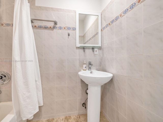 9033 Carlyle Ave, Surfside, FL 33154 - bathroom featuring tile walls and shower / tub combo with curtain