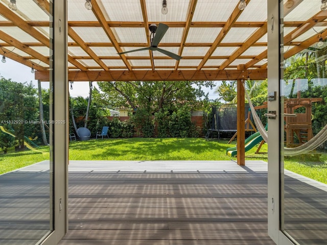 9033 Carlyle Ave, Surfside, FL 33154 - wooden terrace featuring a trampoline, a playground, and a fenced backyard