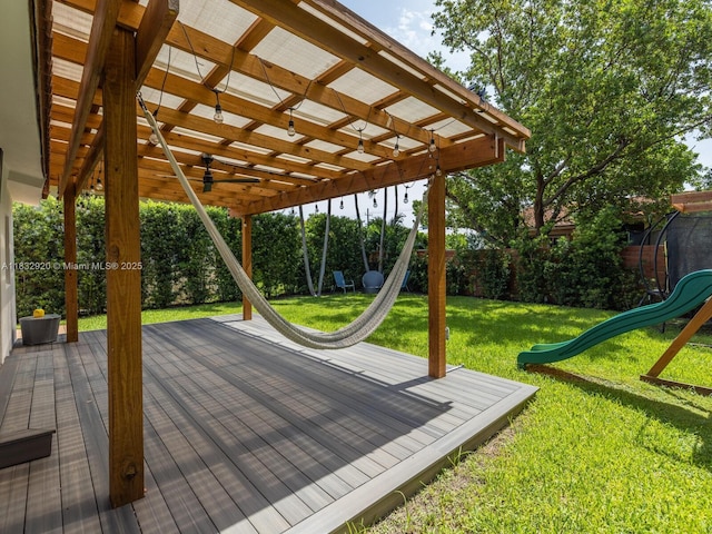 9033 Carlyle Ave, Surfside, FL 33154 - wooden terrace featuring a playground, a ceiling fan, a fenced backyard, and a pergola