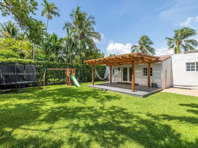 9033 Carlyle Ave, Surfside, FL 33154 - view of green lawn with a trampoline, a pergola, a playground, a wooden deck, and french doors