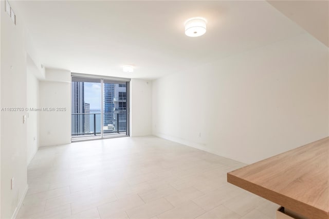 1000 Brickell Plz Unit 3703, Miami, FL 33131 - unfurnished room featuring floor to ceiling windows and baseboards