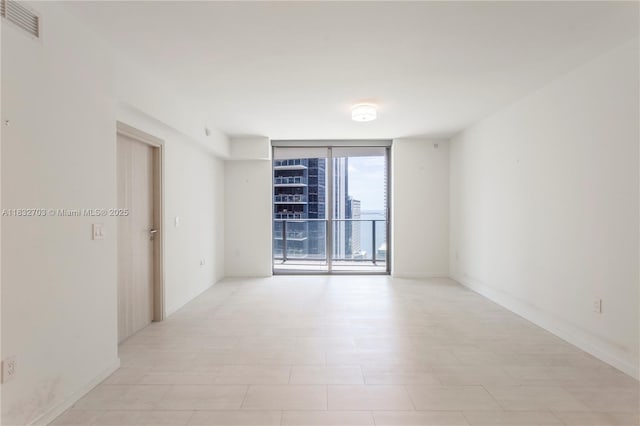 1000 Brickell Plz Unit 3703, Miami, FL 33131 - spare room with floor to ceiling windows