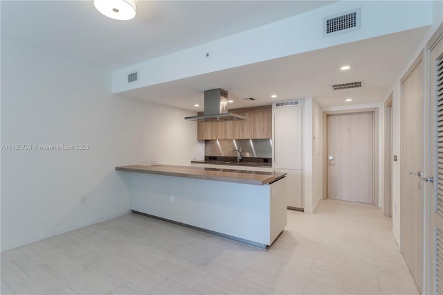 1000 Brickell Plz Unit 3703, Miami, FL 33131 - kitchen featuring island range hood, a peninsula, modern cabinets, recessed lighting, and dark countertops