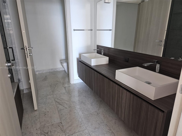 1000 Brickell Plz Unit 3703, Miami, FL 33131 - bathroom with toilet and double vanity